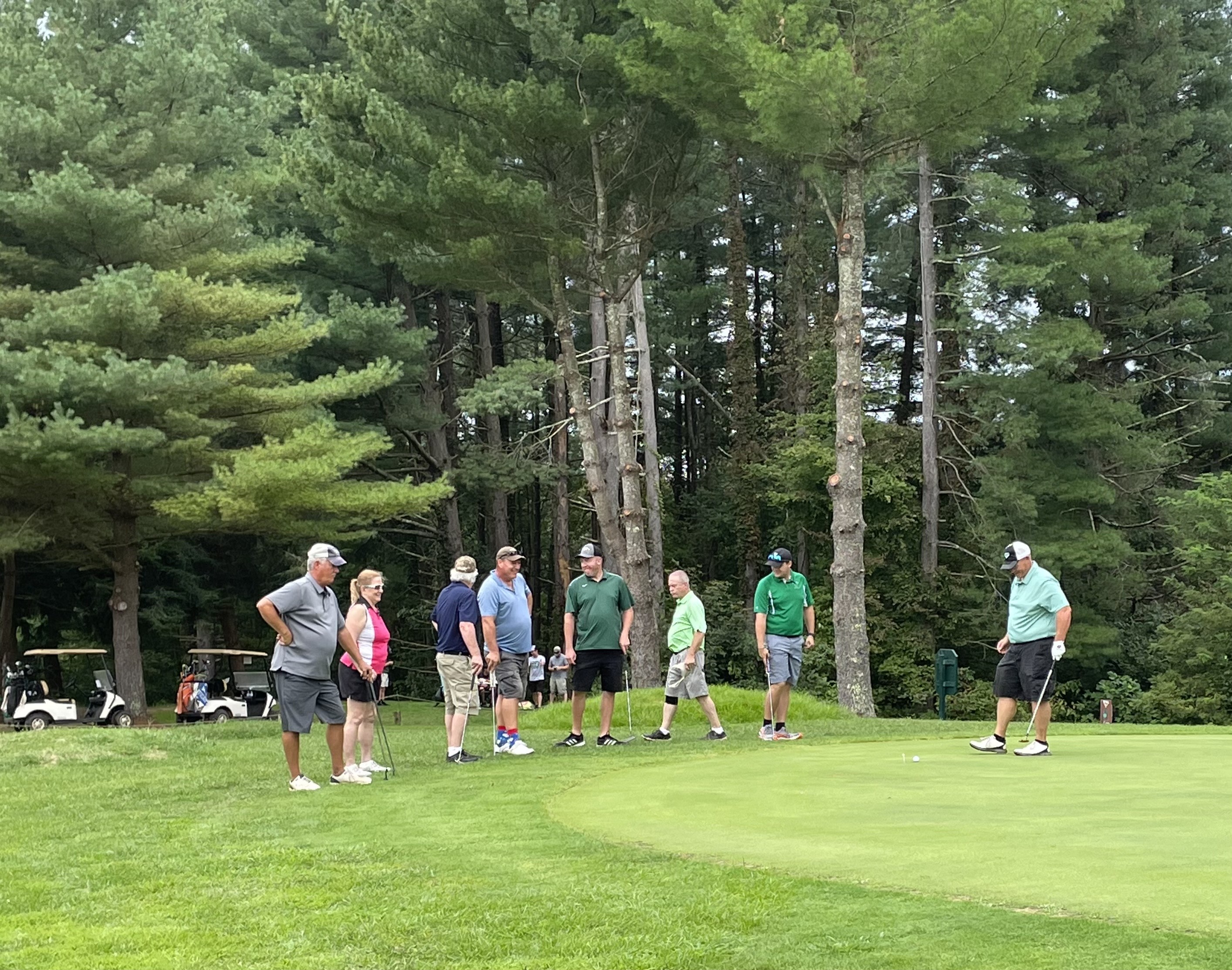 Golfers on golf course green